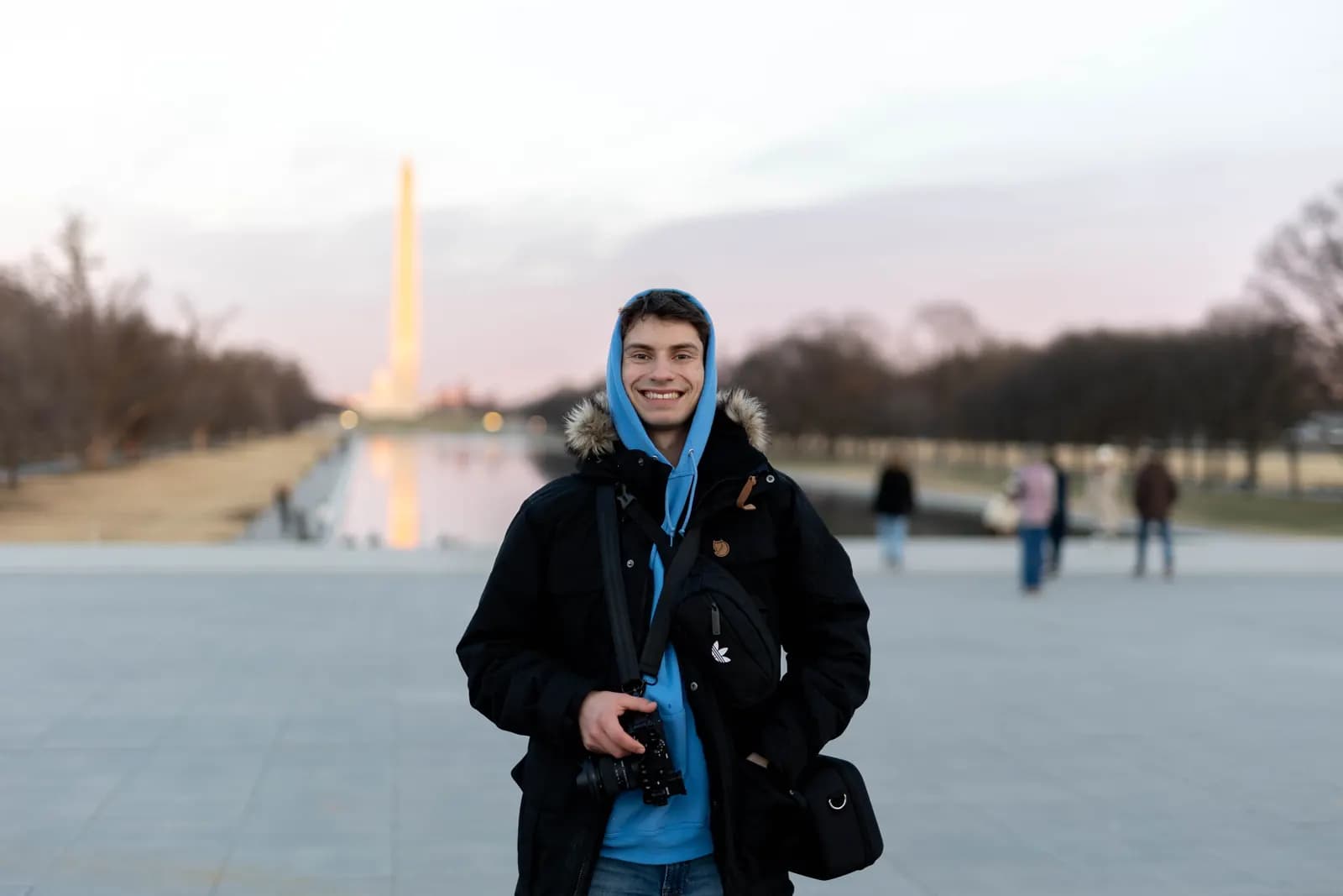 An Ave Maria University student at the Lincoln Memorial reflecting pool, with the Washington Monument in the distance