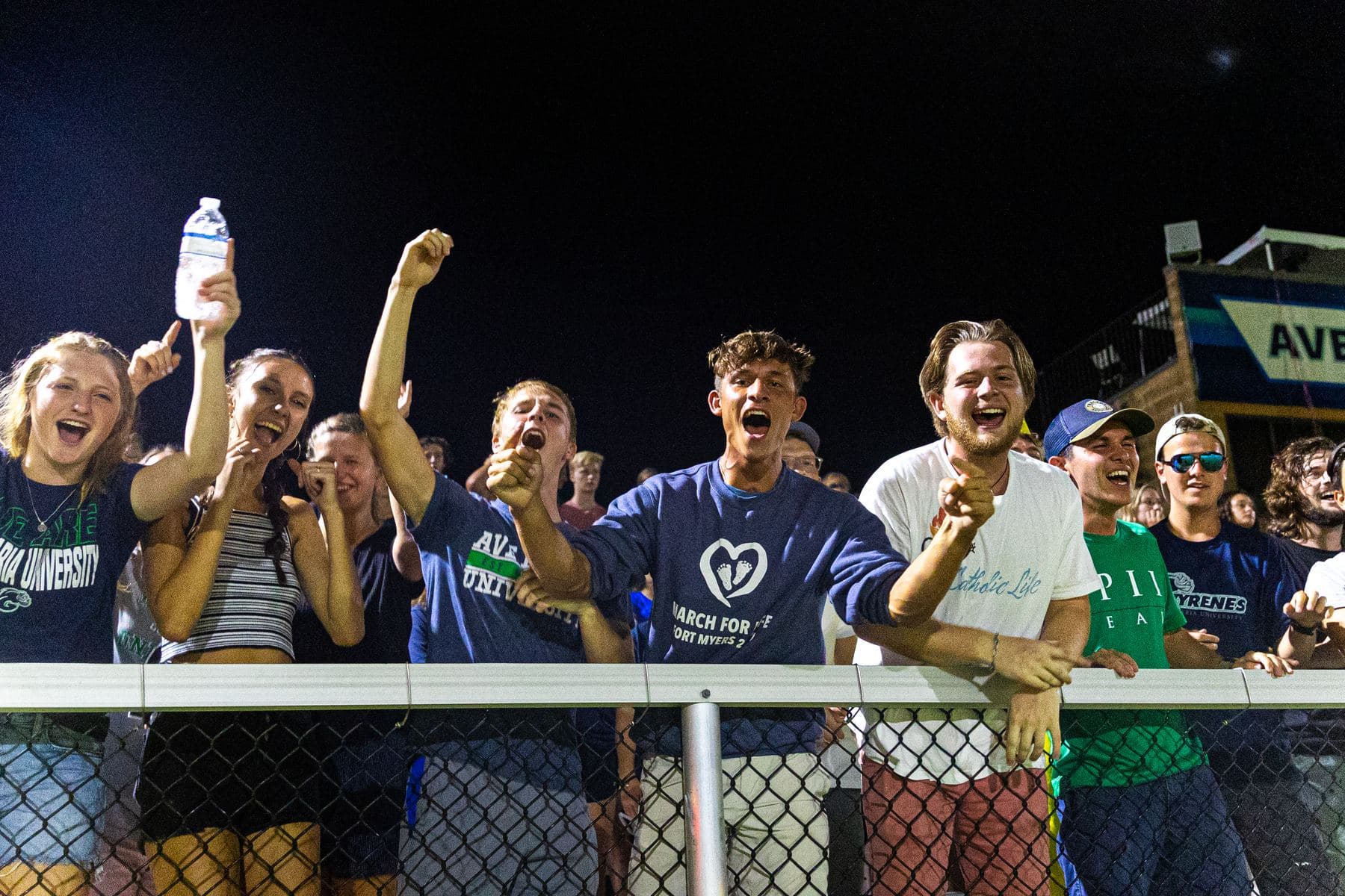 Alumni cheering at an Ave Maria University football game