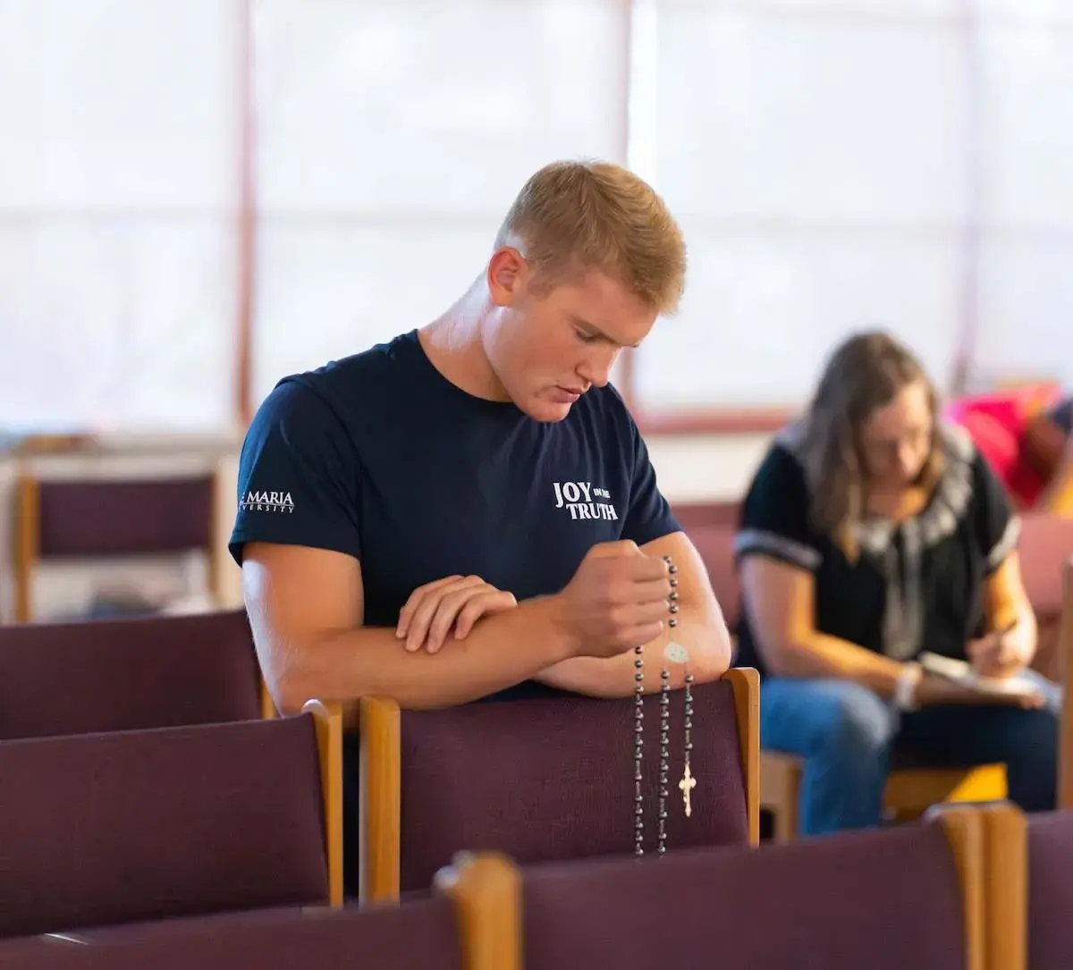 A student praying in the Oratory